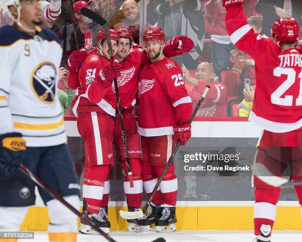 Dylan Larkin of the Detroit Red Wings celebrates his third period goal with teammates Xavier Ouellet, Mike Green and Tomas Tatar as Evander Kane of...