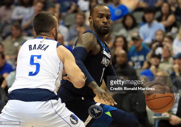 Shabazz Muhammad of the Minnesota Timberwolves dribbles the ball against J.J. Barea of the Dallas Mavericks at American Airlines Center on November...