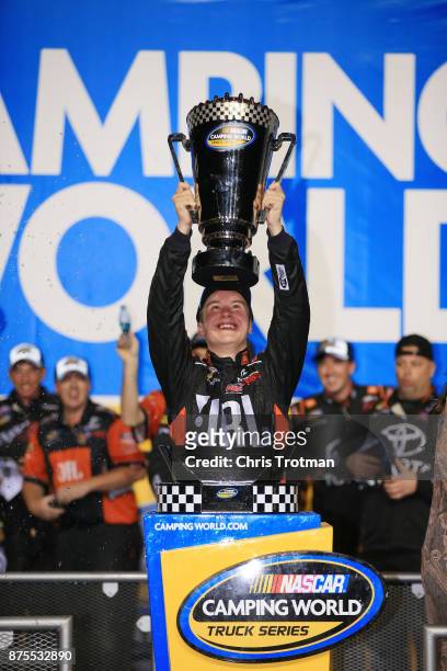 Christopher Bell, driver of the JBL Toyota, celebrates with the trophy in Victory Lane after placing second and winning the Camping World Truck...