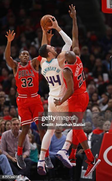 Frank Kaminsky of the Charlotte Hornets puts up a shot between Kris Dunn and Quincy Pondexter of the Chicago Bulls at the United Center on November...
