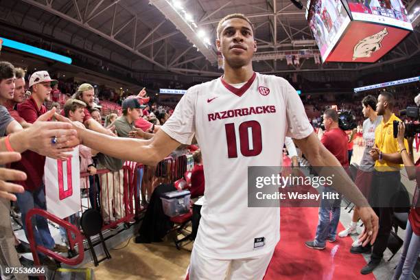 Daniel Gafford of the Arkansas Razorbacks slaps hands with fans after a game against the Fresno State Bulldogs at Bud Walton Arena on November 17,...