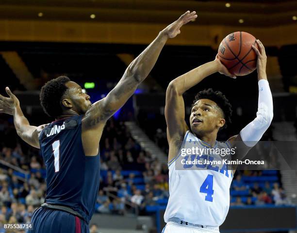 Jaylen Hands of the UCLA Bruins is guarded by Justin Jones of the South Carolina State Bulldogs as he looks to take a shot in the second half of the...