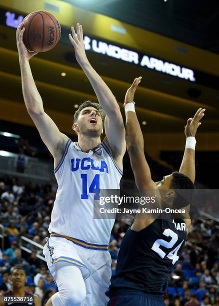 Gyorgy Goloman of the UCLA Bruins goes for a layup over Ian Kinard of the South Carolina State Bulldogs in the second half of the game at Pauley...