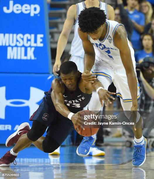 Chris Smith of the UCLA Bruins and Donte Wright of the South Carolina State Bulldogs go for a loose ball in the second half of the game at Pauley...