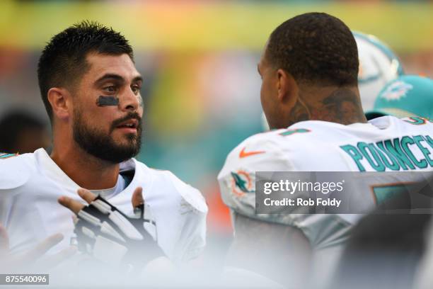 Matt Moore speaks with Mike Pouncey of the Miami Dolphins during the game against the New York Jets at Hard Rock Stadium on October 22, 2017 in Miami...