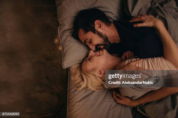 just the two of us - couple cuddling in bed stock pictures, royalty-free photos & images