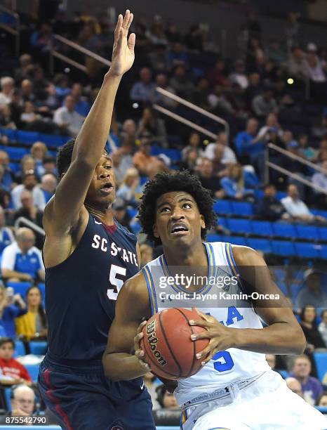 Ozante Fields of the South Carolina State Bulldogs guards Chris Smith of the UCLA Bruins and in the second half of the game at Pauley Pavilion on...