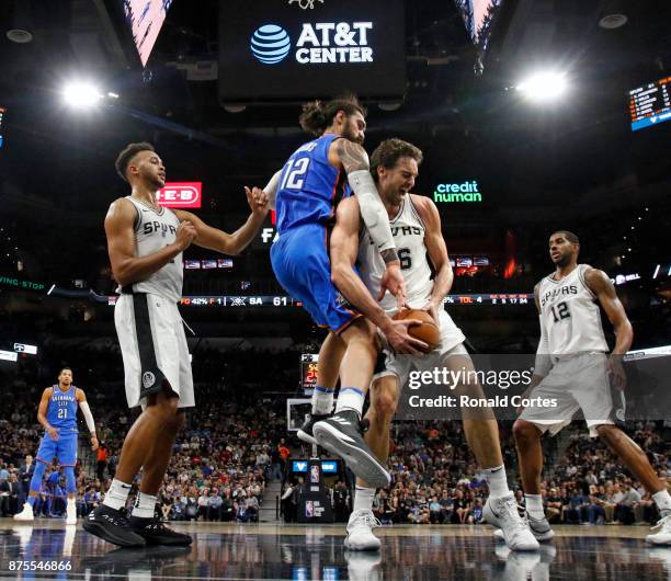 Pau Gasol of the San Antonio Spurs battles Steven Adams of the Oklahoma City Thunder for a rebound at AT&T Center on November 17, 2017 in San...