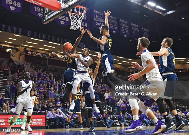Guard Barry Brown of the Kansas State Wildcats drives to the basket between defenders Elston Jones and Jonathan Galloway of the California-Irvine...