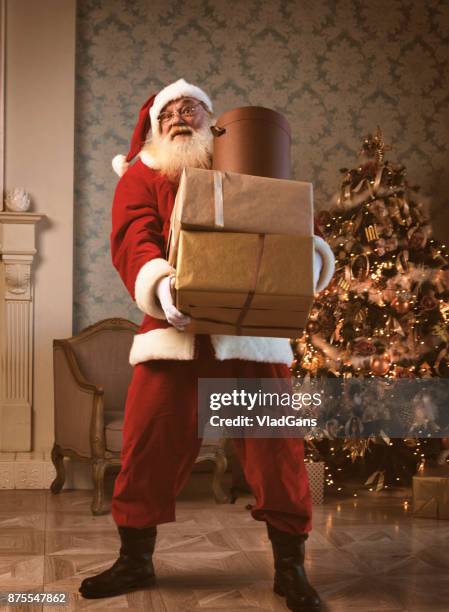 santa claus carrying gifts - santa claus desktop stock pictures, royalty-free photos & images