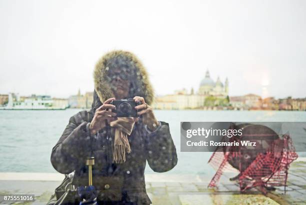 woman taking selfie of her mirror reflection. venice stormy weather. - canale della giudecca stock pictures, royalty-free photos & images