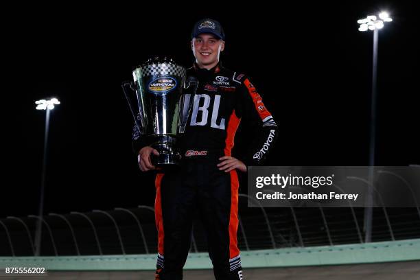 Christopher Bell, driver of the JBL Toyota, poses with the trophy after winning the Camping World Truck Series Championship during the NASCAR Camping...