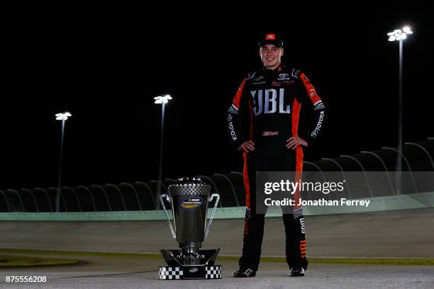 Christopher Bell, driver of the JBL Toyota, poses with the trophy after winning the Camping World Truck Series Championship during the NASCAR Camping...