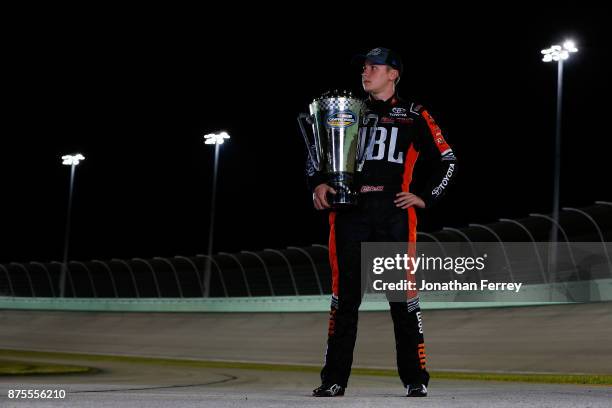 Christopher Bell, driver of the JBL Toyota, poses with the trophy after winning the Camping World Truck Series Championship during the NASCAR Camping...