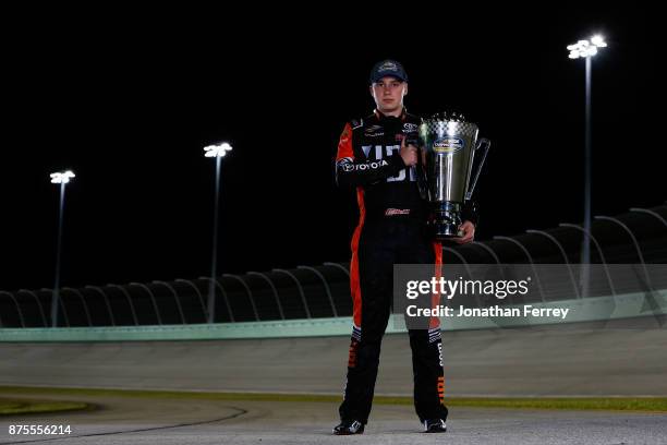 Christopher Bell, driver of the JBL Toyota, poses with the trophy after winning the Camping World Truck Series Championship during the NASCAR Camping...