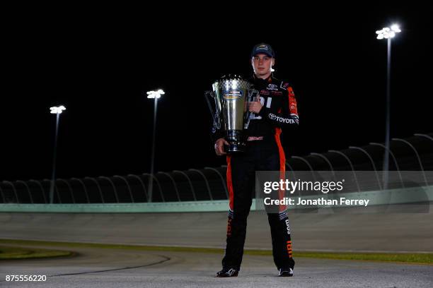 Christopher Bell, driver of the JBL Toyota, poses with the trophy after winning the Camping World Truck Series Championship during the NASCAR Camping...