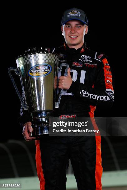 Christopher Bell, driver of the JBL Toyota, poses with the trophy after winning the Camping World Truck Series Championship during the NASCAR Camping...