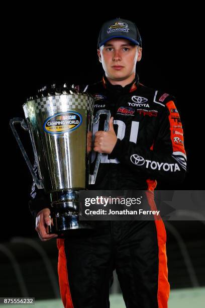 Christopher Bell, driver of the JBL Toyota, poses with the trophy after winning the Camping World Truck Series Championship during the NASCAR Camping...