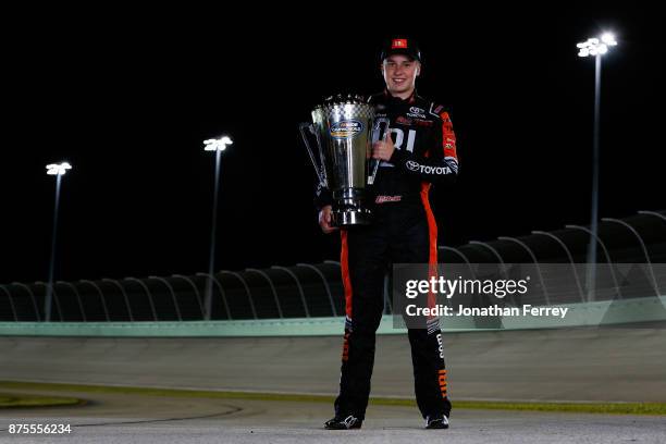 Christopher Bell, driver of the JBL Toyota, poses with the trophy after winning the Camping World Truck Series Championship during the NASCAR Camping...
