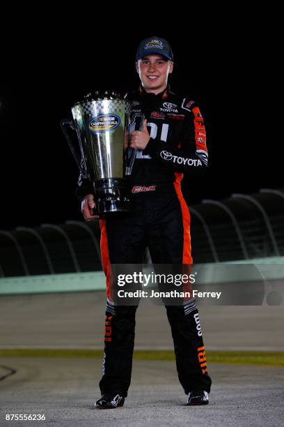 Christopher Bell, driver of the JBL Toyota, poses with the trophy after winning the Camping World Truck Series Championship during the NASCAR Camping...