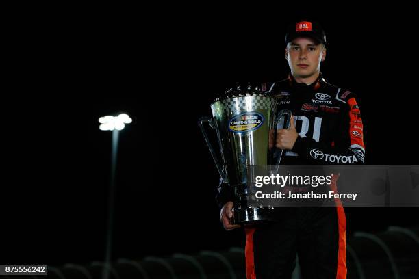 Christopher Bell, driver of the JBL Toyota, poses with the trophy after winning the Camping World Truck Series Championship during the NASCAR Camping...