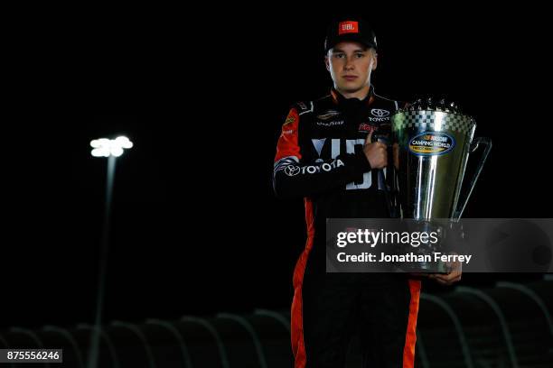 Christopher Bell, driver of the JBL Toyota, poses with the trophy after winning the Camping World Truck Series Championship during the NASCAR Camping...