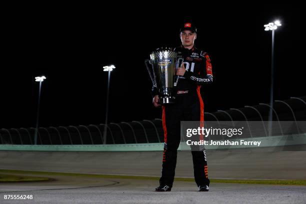 Christopher Bell, driver of the JBL Toyota, poses with the trophy after winning the Camping World Truck Series Championship during the NASCAR Camping...