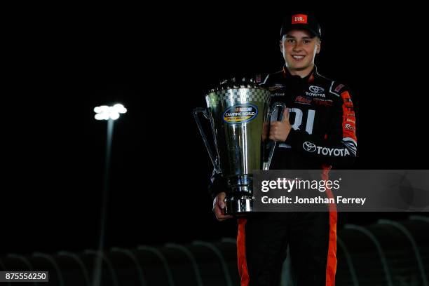 Christopher Bell, driver of the JBL Toyota, poses with the trophy after winning the Camping World Truck Series Championship during the NASCAR Camping...