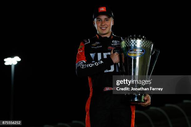 Christopher Bell, driver of the JBL Toyota, poses with the trophy after winning the Camping World Truck Series Championship during the NASCAR Camping...