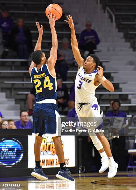 Guard Kamau Stokes of the Kansas State Wildcats pressures the shot of guard Eyassu Worku of the California-Irvine Anteaters during the second half on...