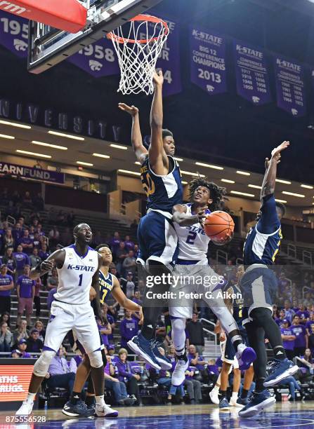 Guard Cartier Diarra of the Kansas State Wildcats drives to the basket between defenders Elston Jones and Max Hazzard of the California-Irvine...