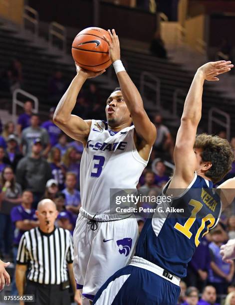 Guard Kamau Stokes of the Kansas State Wildcats shoots the ball against guard Riley Welch of the California-Irvine Anteaters during the second half...