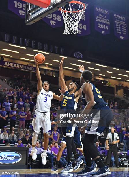 Guard Kamau Stokes of the Kansas State Wildcats drives to the basket against forward Jonathan Galloway of the California-Irvine Anteaters during the...