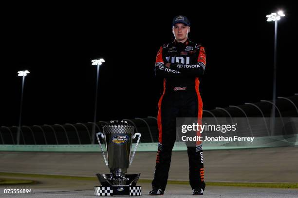 Christopher Bell, driver of the JBL Toyota, poses with the trophy after winning the Camping World Truck Series Championship during the NASCAR Camping...