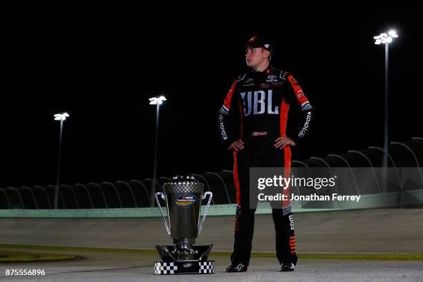 Christopher Bell, driver of the JBL Toyota, poses with the trophy after winning the Camping World Truck Series Championship during the NASCAR Camping...