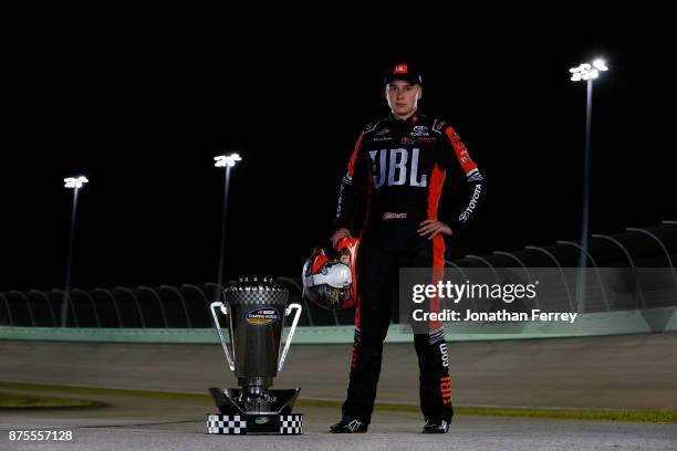 Christopher Bell, driver of the JBL Toyota, poses with the trophy after winning the Camping World Truck Series Championship during the NASCAR Camping...