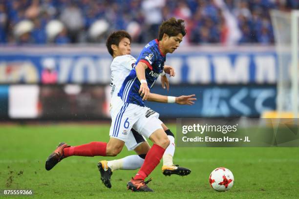 Takahiro Ogihara of Yokohama F.Marinos is tackled by Yoichiro Kakitani of Cerezo Osaka during the J.League J1 match between Yokohama F.Marinos and...