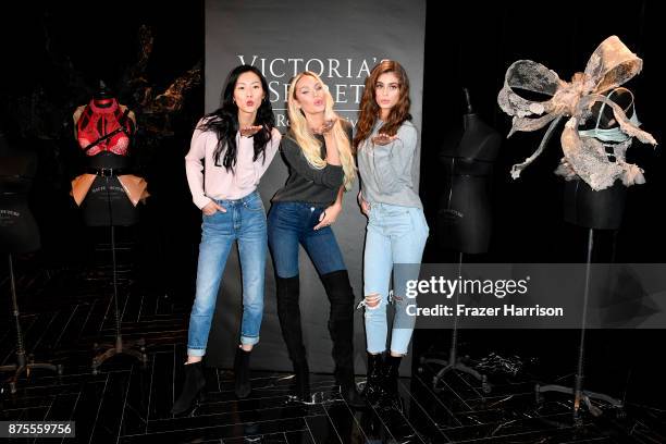 Liu Wen, Candice Swanpoel and Taylor Hill pose at the Victoria's Secret Store At Lippo Plaza Appearance at Victoria's Secret on November 18, 2017 in...