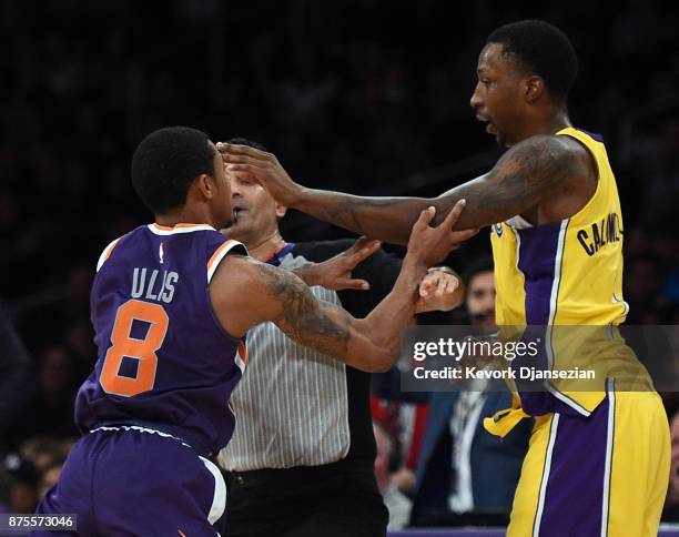 Tyler Ulis of the Phoenix Suns and Kentavious Caldwell-Pope of the Los Angeles Lakers push each other as they separated by referee Zach Zarba during...