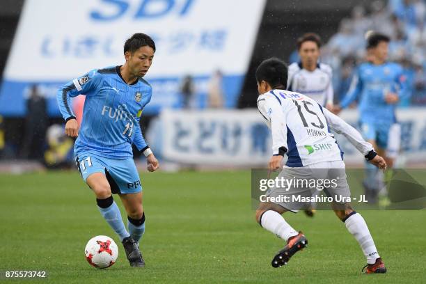 Yu Kobayashi of Kawasaki Frontale and Yasuyuki Konno of Gamba Osaka compete for the ball during the J.League J1 match between Kawasaki Frontale and...