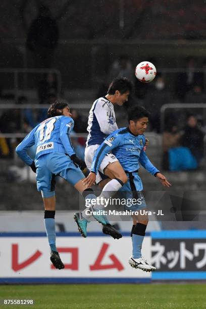 Koki Yonekura of Gamba Osaka competes for the ball against Elsinho and Ryota Oshima of Kawasaki Frontale during the J.League J1 match between...