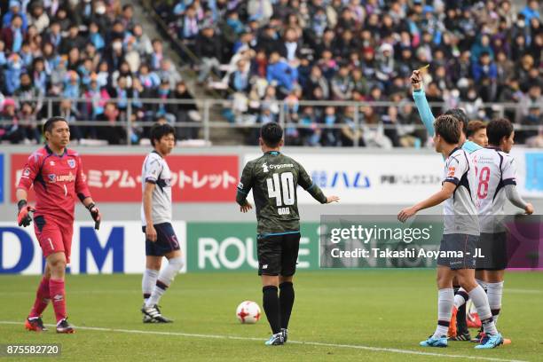 Yuji Ono of Sagan Tosu is shown a yellow card by referee Itaru Hirose during the J.League J1 match between Sagan Tosu and FC Tokyo at Best Amenity...