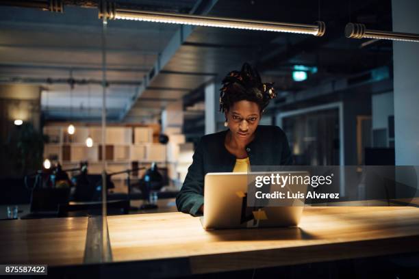 businesswoman working late on laptop - working overtime stock pictures, royalty-free photos & images