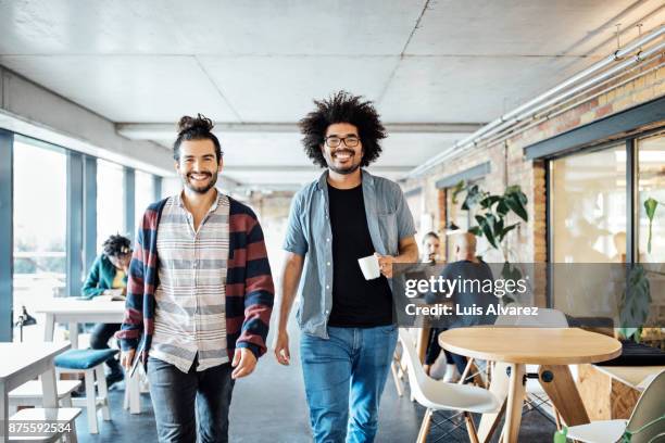 portrait of smiling business people at cafeteria - business group portrait stock-fotos und bilder