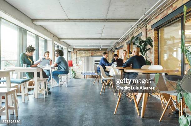 business people talking in office cafeteria - comedor edificio de hostelería fotografías e imágenes de stock