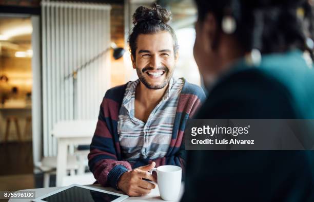 happy businessman having coffee with colleague - positive emotion stock-fotos und bilder