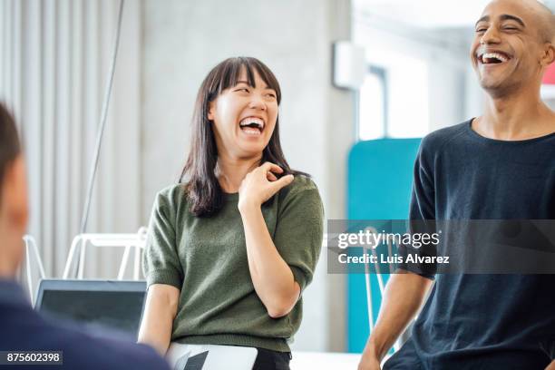 cheerful business colleagues in meeting - casual work men and women laughing stock pictures, royalty-free photos & images