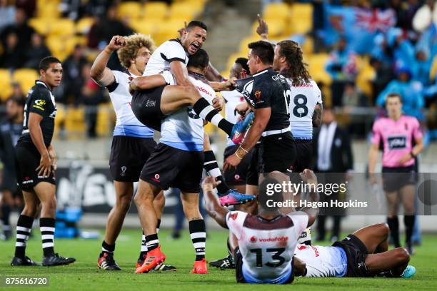 Marcelo Montoya and Jarryd Hayne of Fiji celebrate the win at the final whistle during the 2017 Rugby League World Cup Quarter Final match between...