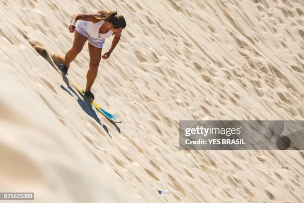 sandboarders in the joaquina dunes - sand boarding stock pictures, royalty-free photos & images