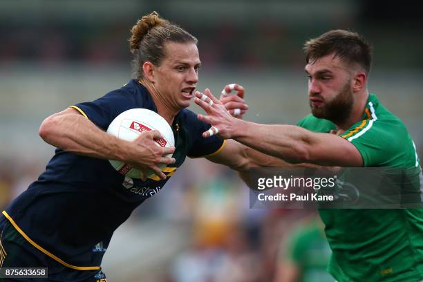 Nathan Fyfe of Australia fends off a tackle by Aidan O'Shea of Ireland during game two of the International Rules Series between Australia and...